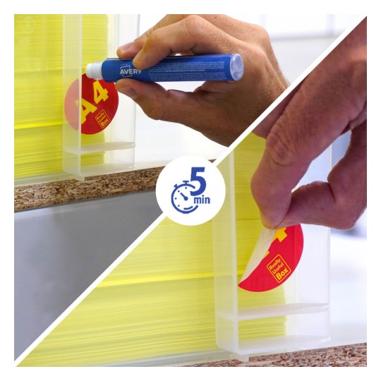 Hand applying and peeling a round red label from a clear plastic dispenser of yellow cards